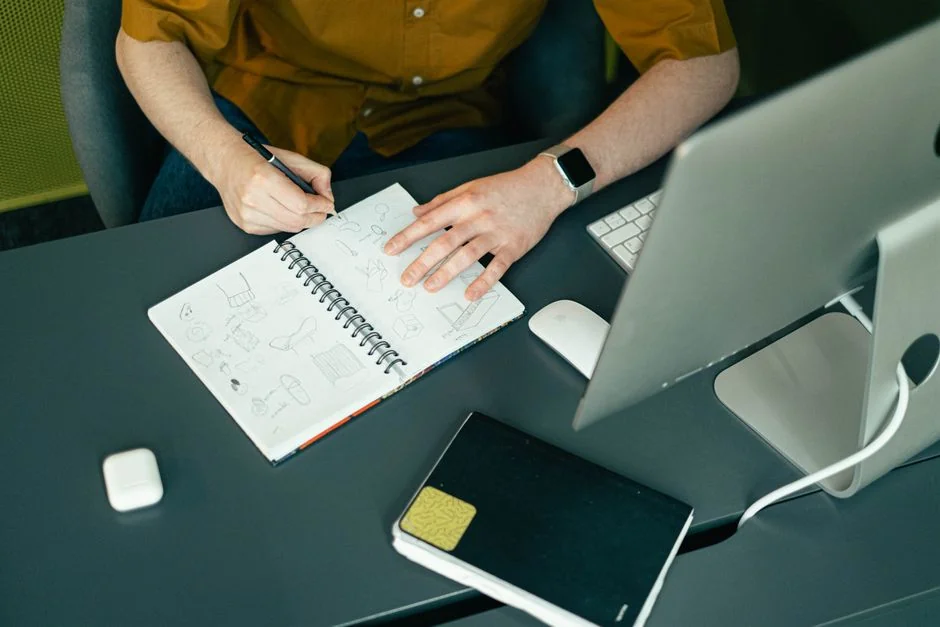 High-angle view of a stylish work desk featuring dual monitors, keyboard, mouse, and modern accessories.